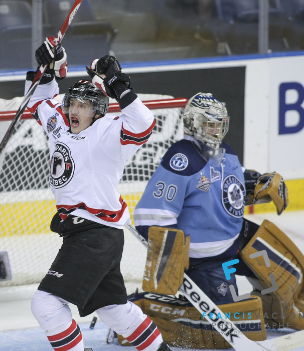Quebec Remparts forward Jerome Verrier celebrates his goal as Rimouski Oceanic goal keeper Louis-Philip Guindo looks down in first period action at the Memorial cup tiebreaker at Le Colisee Pepsi in Quebec city Thursday May 28, 2015.