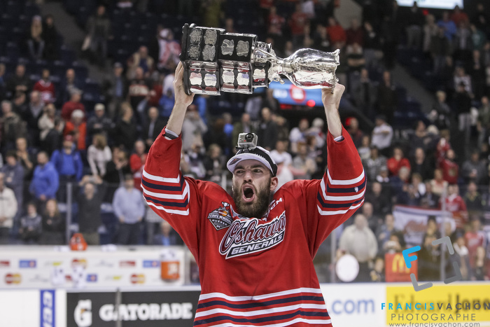 Oshawa Generals' Hunter Smith raises the Memorial Cup after winning the final against the Kelowna Rockets in Quebec City on Sunday May 31, 2015. Francis Vachon/Postmedia Network
