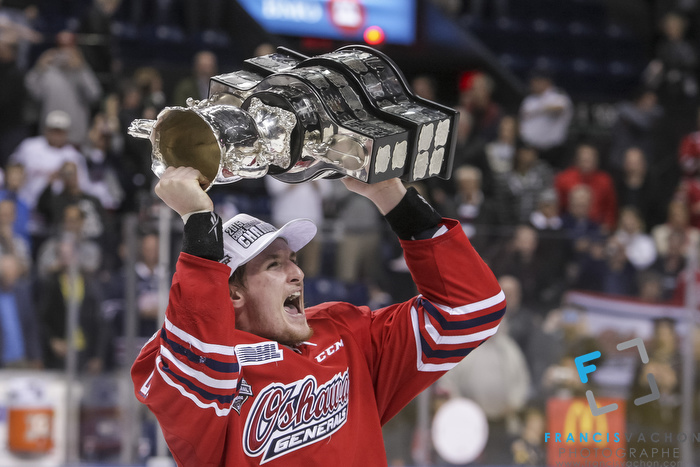 Oshawa Generals' Michael McCarron raises the Memorial Cup after winning the final against the Kelowna Rockets in Quebec City on Sunday May 31, 2015. Francis Vachon/Postmedia Network