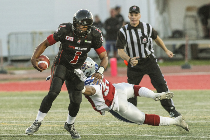 Montreal Alouettes' Chris Bakers tackles Ottawa Redblacks' Henry Burris during CFL action in Quebec City on Saturday June 13, 2015. Francis Vachon/Postmedia Network