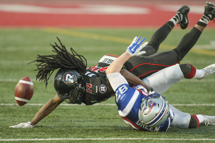 Montreal Alouettes Brandan Green and Ottawa Redblacks' Abdul Kanneh fight for the ball during CFL action in Quebec City on Saturday June 13, 2015. Francis Vachon/Postmedia Network