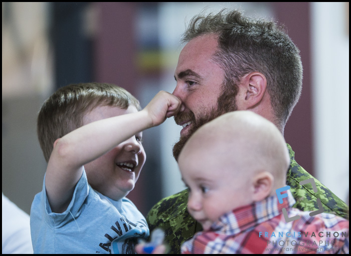 William Leclerc pinches the nose of his father Francois Leclerc as he holds his other son Felix-Antoine as they are gathered at CFB Valcartier, north of Quebec City, before leaving for Poland on Sunday June 28, 2015. An initial group of Canadian Armed Forces members from Valcartier are leaving for Poland this Sunday to take part in the 4th rotation of Operation REASSURANCE.