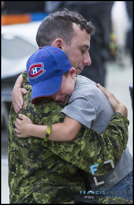 Corporal Chevalier hugs his son as they are gathered at CFB Valcartier, north of Quebec City, before leaving for Poland on Sunday June 28, 2015. An initial group of Canadian Armed Forces members from Valcartier are leaving for Poland this Sunday to take part in the 4th rotation of Operation REASSURANCE. 
