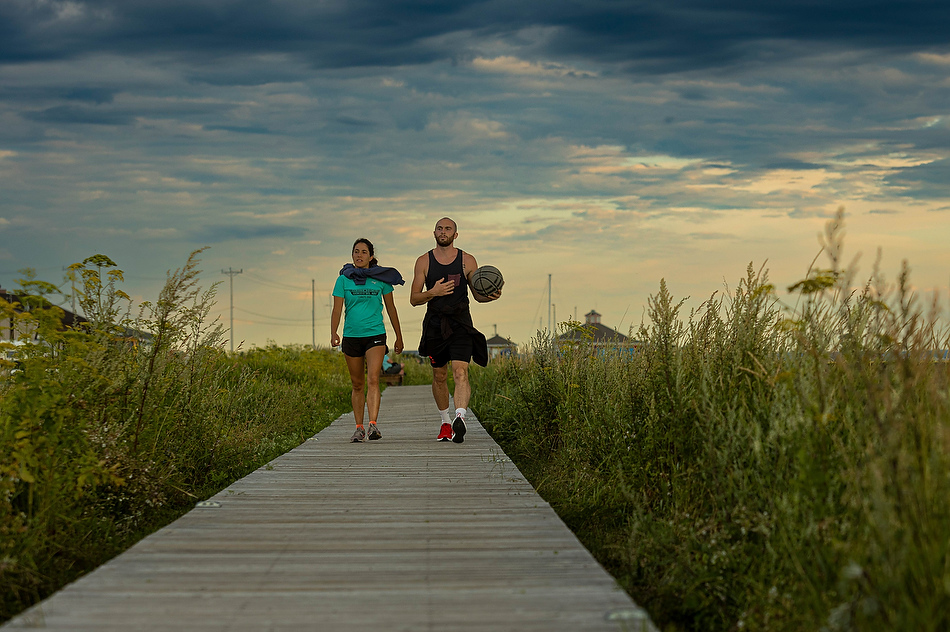 Un homme et une femme marchent sur la promenade des Acadiens, à Carleton-sur-Mer