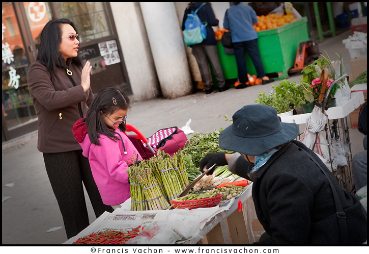 A woman and her daughter look at vegetables on display on a stall installed on the sidewalk on Spadina avenue in Toronto Chinatown April 23, 2010. Toronto Chinatown is an ethnic enclave in Downtown Toronto with a high concentration of ethnic Chinese residents and businesses extending along Dundas Street West and Spadina Avenue. The Canadian Press Images/Francis Vachon