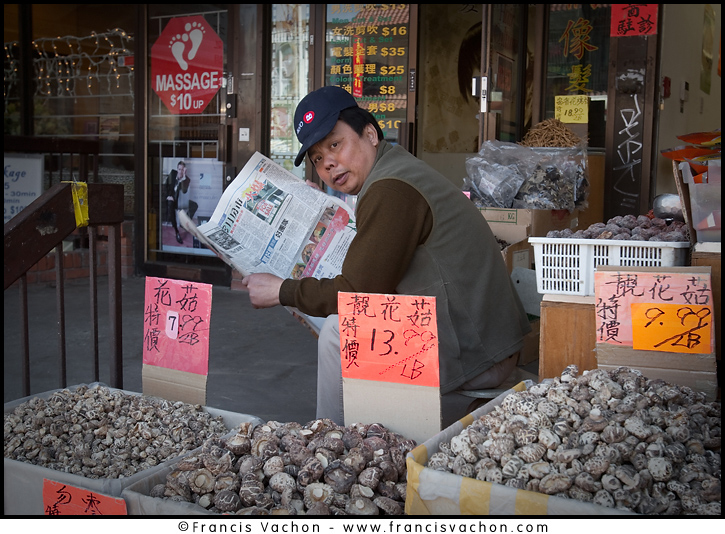 A vendor reading a Chinese newspaper is seen behind stalls in Toronto Chinatown April 23, 2010. Toronto Chinatown is an ethnic enclave in Downtown Toronto with a high concentration of ethnic Chinese residents and businesses extending along Dundas Street West and Spadina Avenue. The Canadian Press Images/Francis Vachon