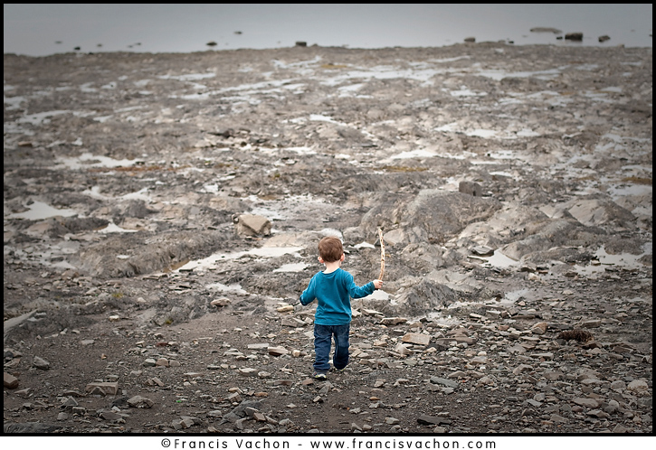 Kid on a shingle beach